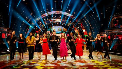 The Strictly Come Dancing Christmas special celebrities and their pro partners link arms and dance in a line across the ballroom