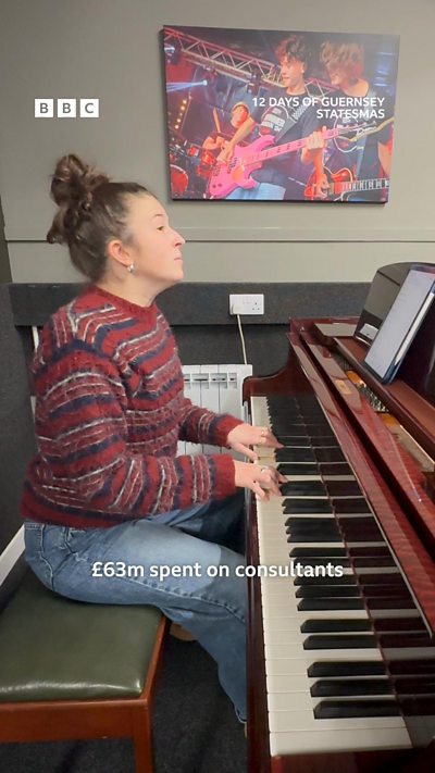 A woman sits playing a grand piano