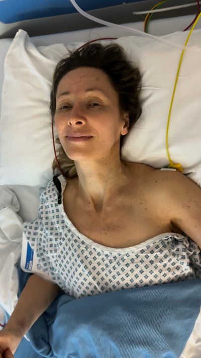 Lady lying in a hospital bed