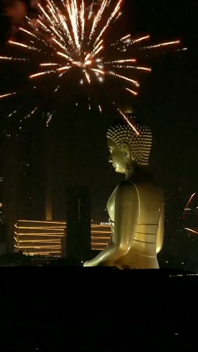 Firework exploding on top of statue of buddha