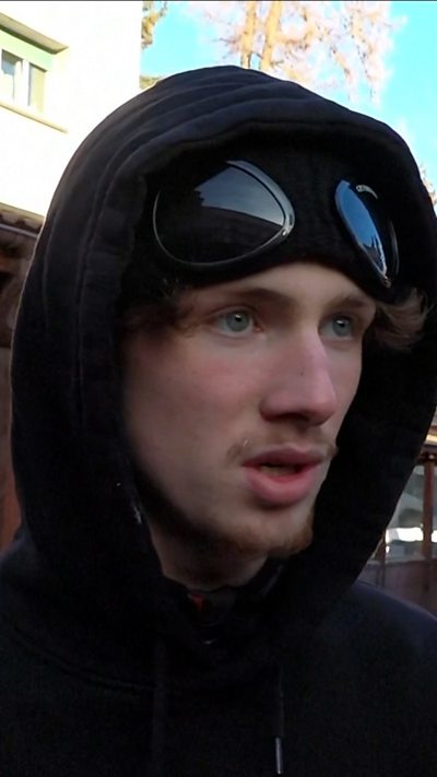 Man wearing black hat and hoodie
