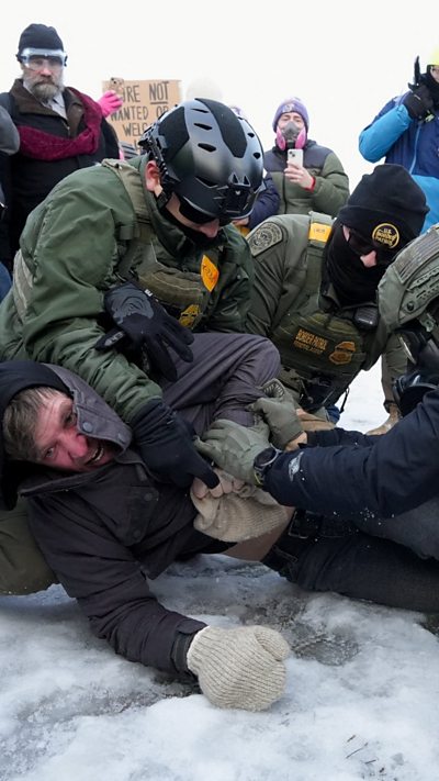Border Patrol federal agents detain a demonstrator at a protest against the fatal shooting of Renee Nicole Good.