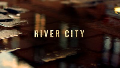Logo for River City featuring the show’s title on an image of puddles amidst cobblestones.