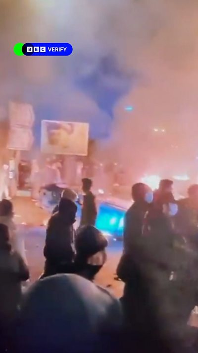 A screengrab from a video taken in Iran showing protesters in front of fire