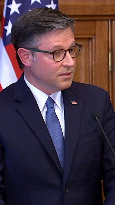 US Speaker Mike Johnson addresses the UK Parliament. Behind him is an American flag.