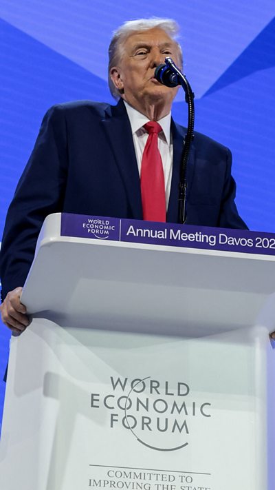 US President Donald Trump speaking at podium during Davos summit