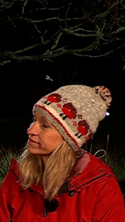 A barn owl glides in the distance, behind Michaela Strachan