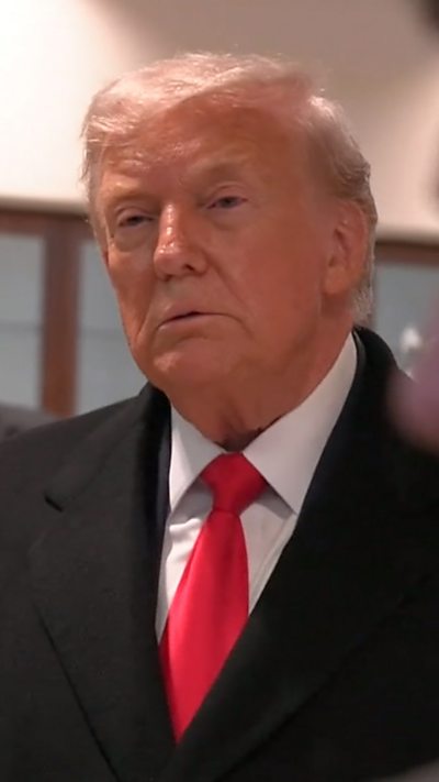 President Trump wearing a red tie and black suit.