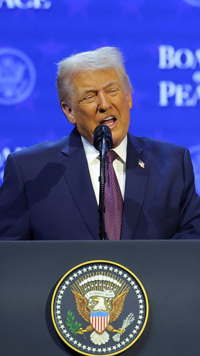Trump on stage during Board of Peace speech