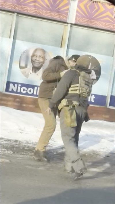 Two men face standing close to each other on a road