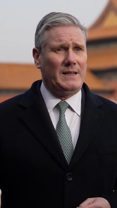 Starmer standing for interview in Beijing