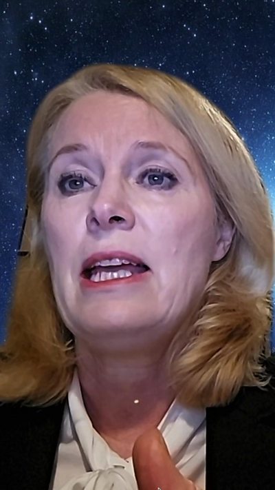 Jo White has blonde hair, cream blouse and dark jacket