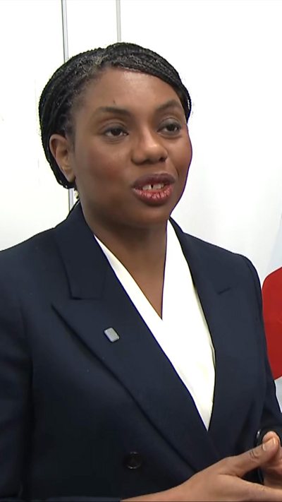 Kemi Badenoch wearing a white blouse and jacket