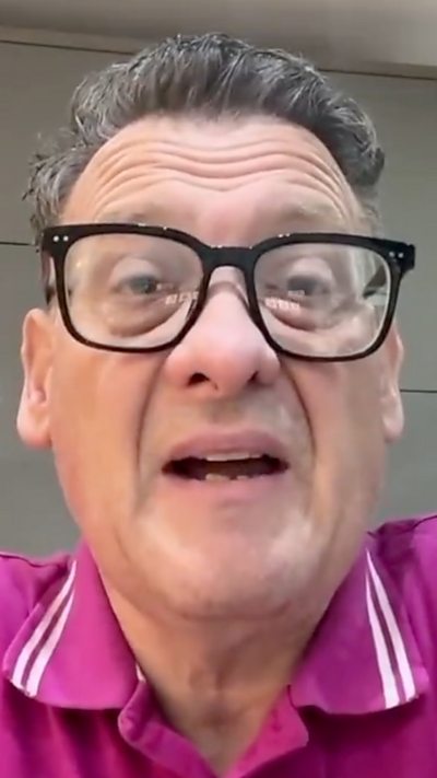 Karl Turner MP on zoom in a pink shirt