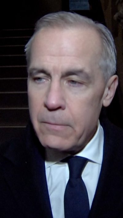A man in a suit with grey hair looking sad.
