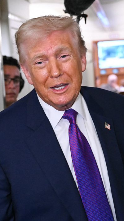 US President Donald Trump speaks to reporters on Air Force One before taking off from Joint Base Andrews.