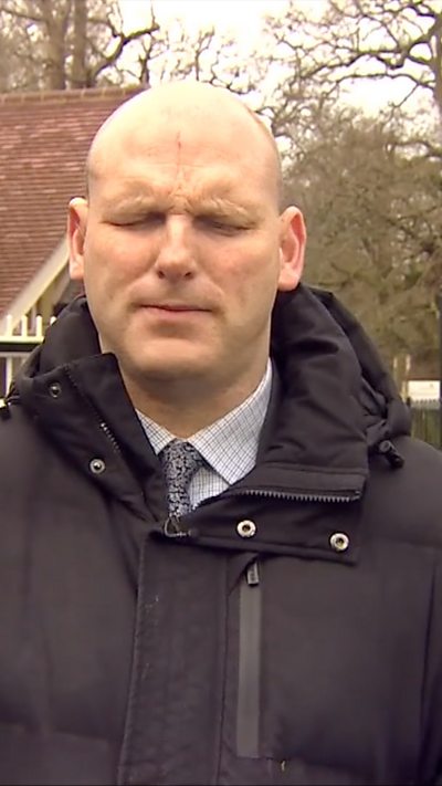 Sean Dilley in a black coat outside.