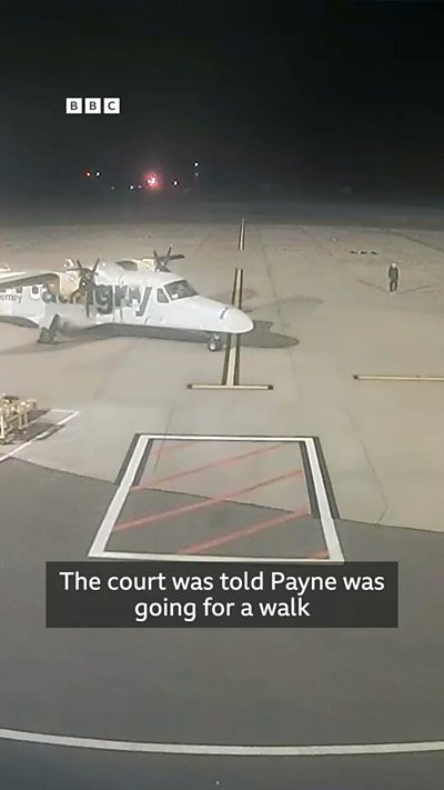 CCTV of a man walking past a Dornier aircraft on an airport stand