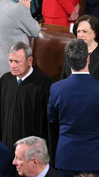 Supreme Court justices are entering the room.