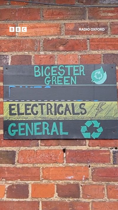 A brick wall with a sign saying Bicester Green