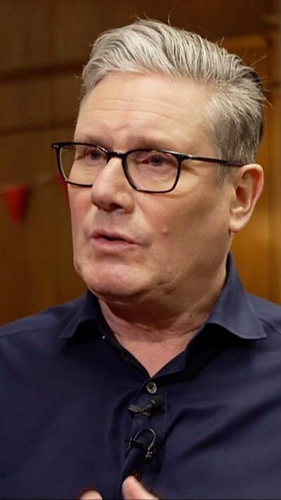 Sir Keir Starmer wearing a blue shirt