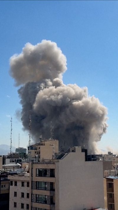 Smoke cloud rising over Tehran's skyline
