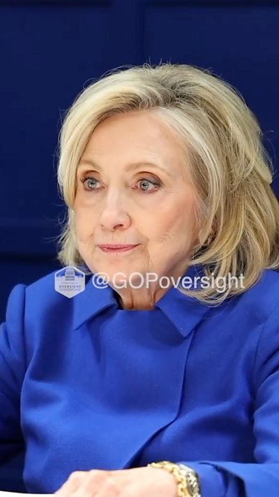 Hillary Clinton is seen talking to members of Congress.
