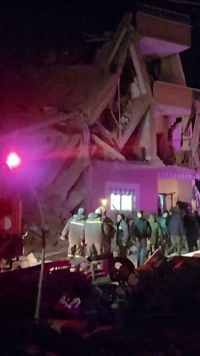 Rescue workers outside a crumbled building in Lebanon
