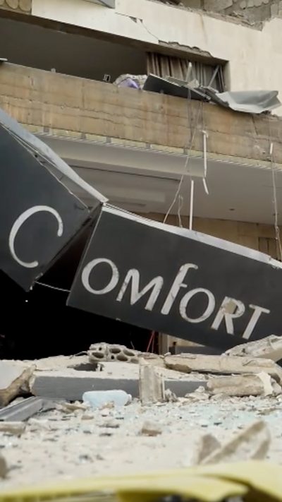 Damaged hotel sign that reads Comfort