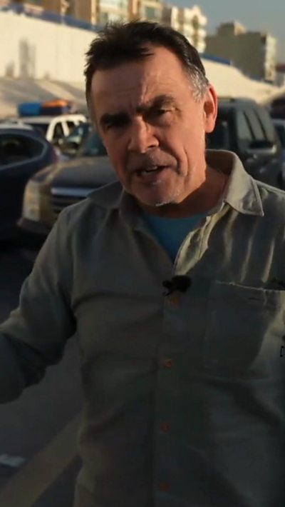 Wyre Davies stands in front of traffic