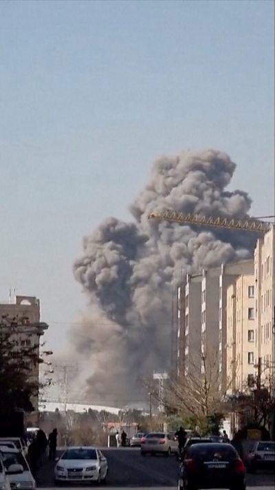 Plumes of smoke billow from Tehran stadium