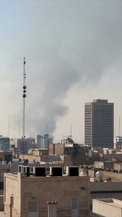Skyline of Tehran with smoke in the background