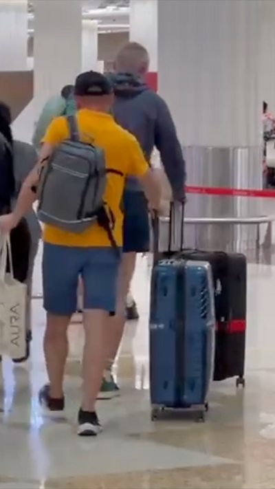 People with luggage at Dubai airport