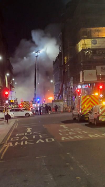 Union st fire from a distance with plumes of smoke and crowds of emergency services
