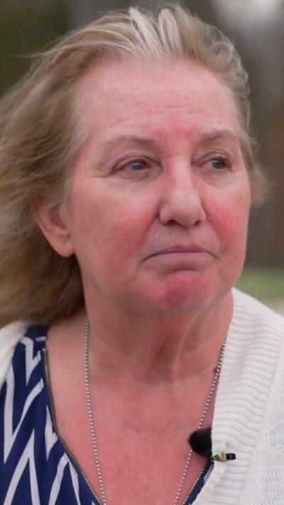 A woman stares wistfully.