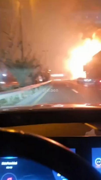 Huge fire on road seen from inside car from driver's seat