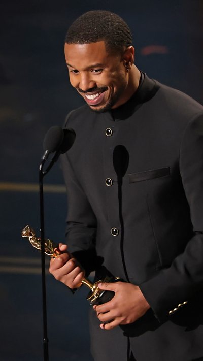 Michael B Jordan is seen holding an Oscars.