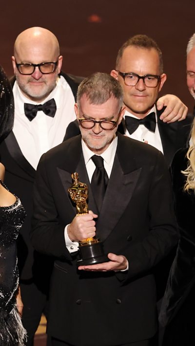 Paul Thomas Anderson accepts award for best picture.
