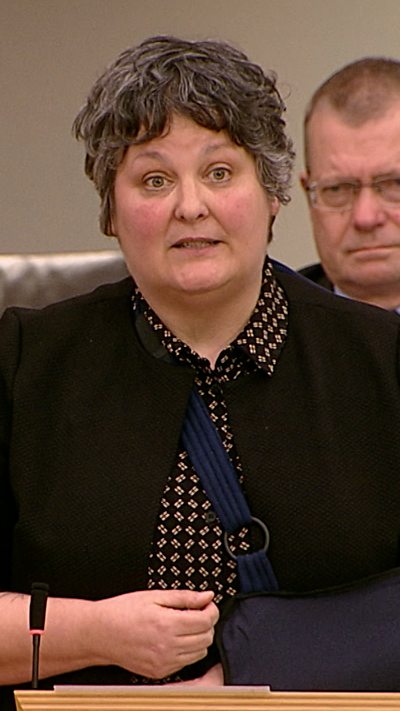 A woman in a dark top in the Scottish Parliament chamber