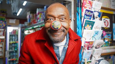 Close-up image of Sir Lenny Henry wearing a red nose for Comic Relief. 