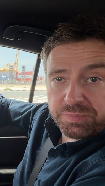 BBC correspondent Nick Beake sat inside a car driving through Dubai's Port of Jebel Ali
