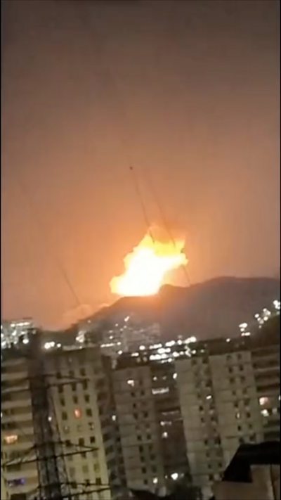 A large explosion in the distance above tower blocks in Caracas