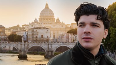 A picture of Harry Clark in front of the Rome skyline, with St Peter's basilica prominent in the background.