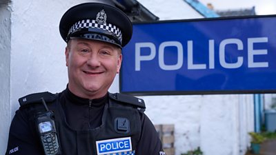 PC Plum outside his police station