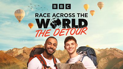 Two men smile wearing backpacks against the backdrop of mountains and hot air balloons. Race Across The World The Detour is written across the sky.