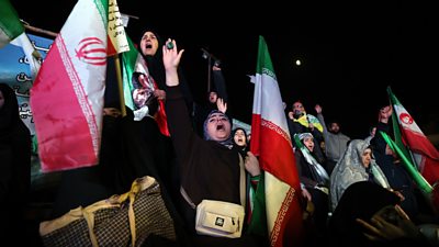 Women wave Iranian flag at Tehran demonstration
