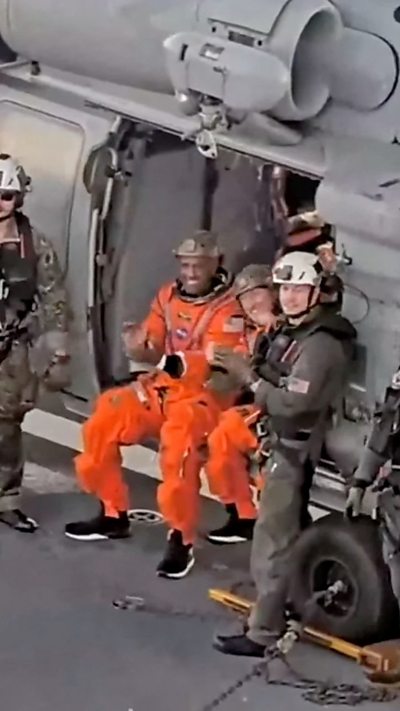 Crew members Christina Koch and Victor Glover aboard a recovery ship.