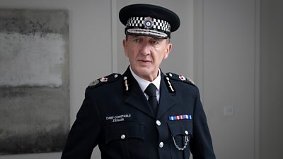 Photo of Ralph Ineson in character as Chief Constable Ziegler. He wears the formal police uniform of a Chief Constable.