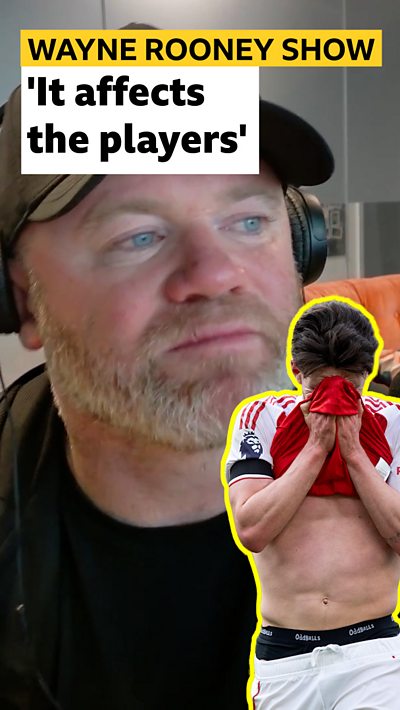 Wayne Rooney looks at a cut out of Declan Rice with his face in his hands