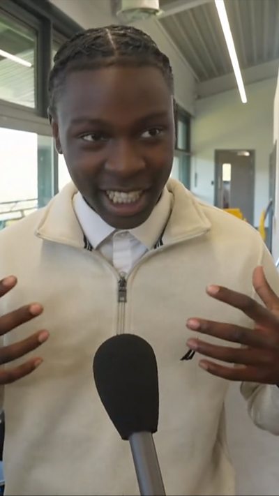 Student speaks into microphone